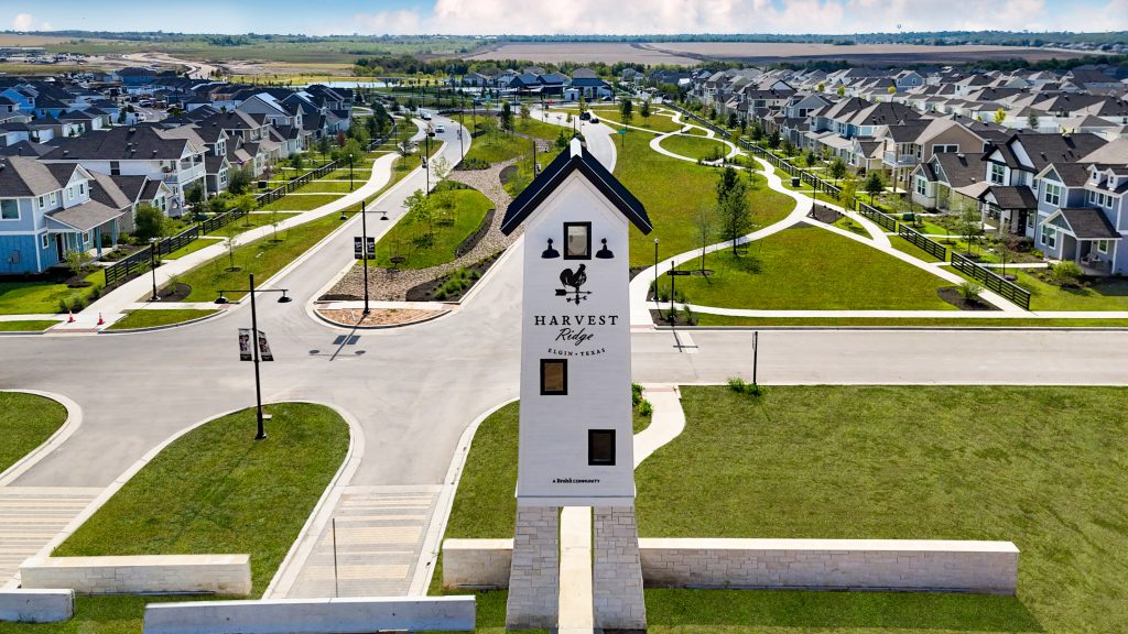 Image of white house structure at entry of Harvest Ridge community by Brohn Homes