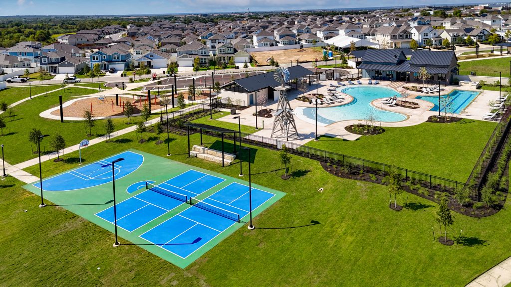 Aerial image of Harvest Ridge amenities, such as a pickleball court and the swimming pool